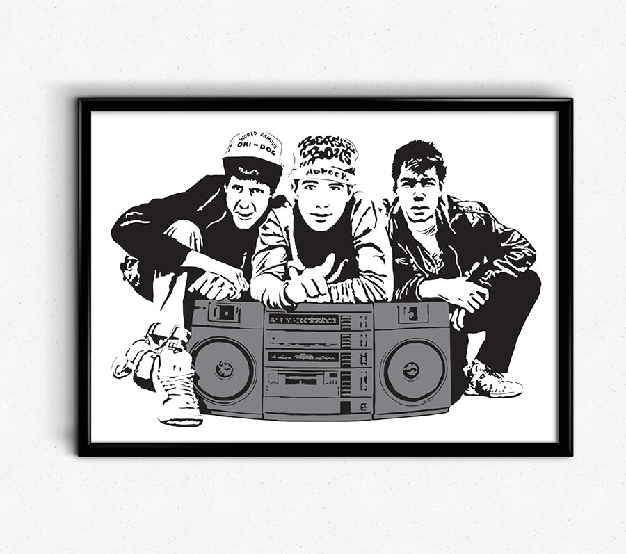 digital minimalist stencil illustration of the beastie boys hip hop group featuring ad-rock, MCA, and Mike D crouching behind a large boom box tape deck, illustration is black and white except the boombox is colored in with grey, print is framed on the wall