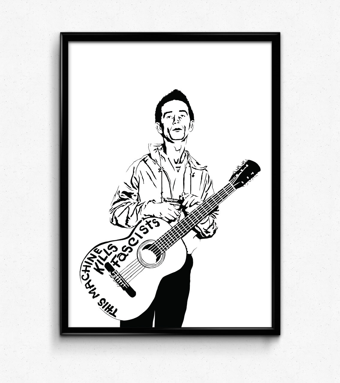 digital minimalist stencil illustration of folk guitarist and musician woody guthrie holding his guitar which has writing that says "this machine kills fascists", framed art print